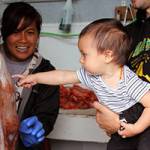 Kim Uddipa Mork and Mitch Mork show their son, Owen Mork, their octopus catch. (Courtesy Photo | Mitch Mork.)