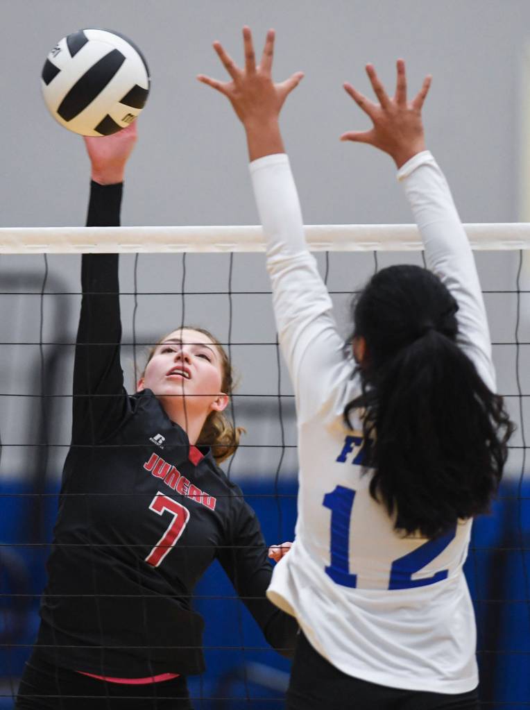 Juneau-Douglas Jojo Griggs, left, spikes the ball against Thunder Mountains Mariah Tanuvasa-Tuvaifale at Thunder Mountain High School on Friday, Oct. 4, 2019. (Michael Penn | Juneau Empire)