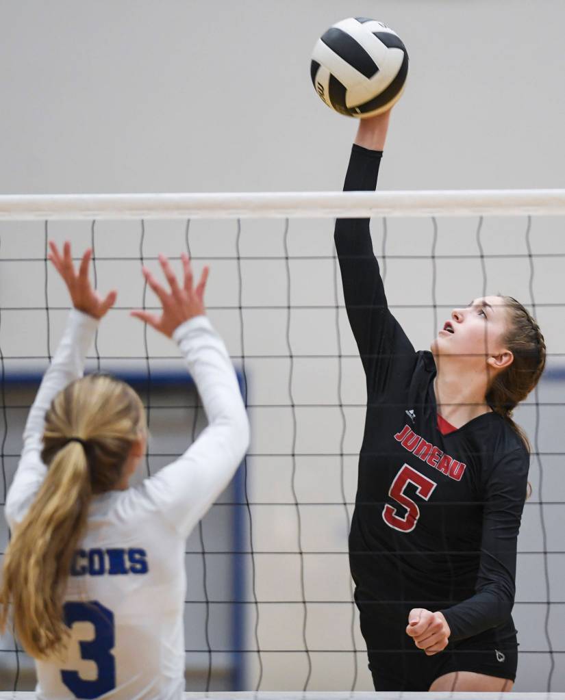 Juneau-Douglas Brooke Sanford, right, spikes the ball against Thunder Mountains Lily Smith at Thunder Mountain High School on Friday, Oct. 4, 2019. (Michael Penn | Juneau Empire)