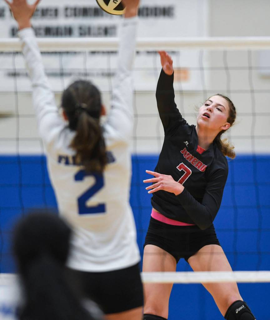 Juneau-Douglas Jojo Griggs, right, spikes against Thunder Mountains Amy Schoonover at Thunder Mountain High School on Friday, Oct. 4, 2019. (Michael Penn | Juneau Empire)