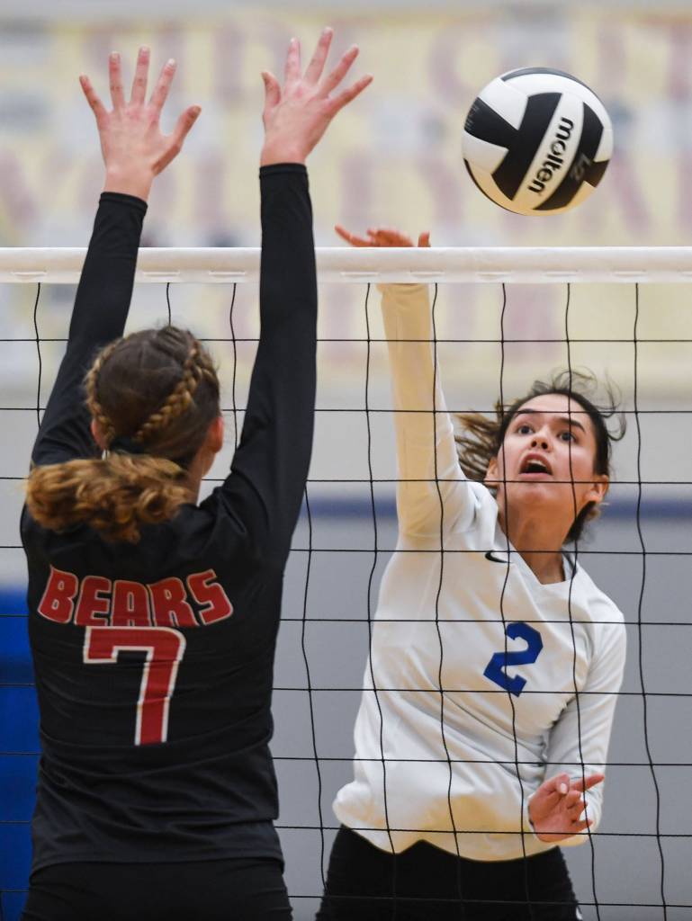Thunder Mountains Amy Schoonover, right, spikes against Juneau-Douglas Jojo Griggs at Thunder Mountain High School on Friday, Oct. 4, 2019. (Michael Penn | Juneau Empire)