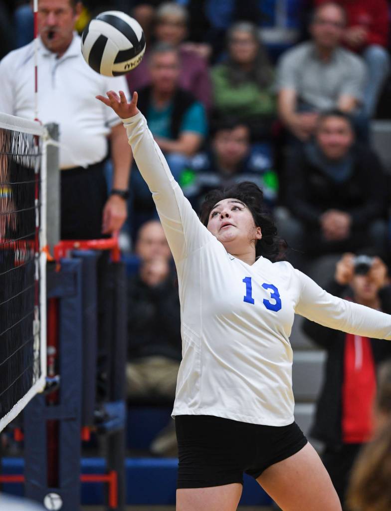 Thunder Mountains Letasi Fenumiai tips the ball over the net against Juneau-Douglas at Thunder Mountain High School on Friday, Oct. 4, 2019. (Michael Penn | Juneau Empire)