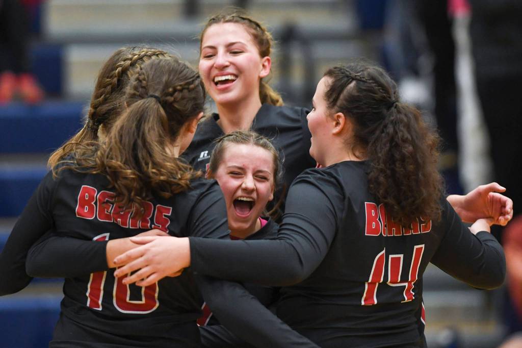 Juneau-Douglas Kiana Potter, center below, celebrates a point with her teammates against Thunder Mountain at Thunder Mountain High School on Friday, Oct. 4, 2019. (Michael Penn | Juneau Empire)