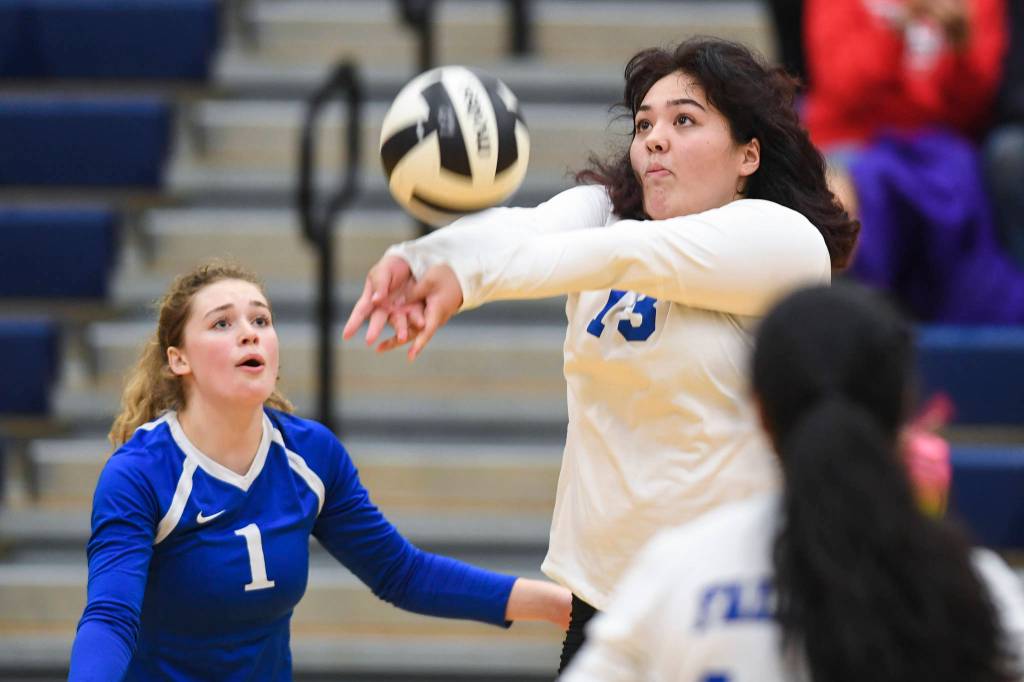 Thunder Mountains Letasi Fenumiai, right, bumps the ball up next to teammate Bridget Gehring as they play against Juneau-Douglas at Thunder Mountain High School on Friday, Oct. 4, 2019. (Michael Penn | Juneau Empire)