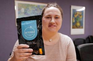 Jessica Spurrier, the Juneau Opioid Work Group Facilitator for JAMHI Health & Wellness, Inc., holds up a drug deactivation bag on Tuesday, Oct. 1, 2019. The bags make unused prescriptions safe to dispose of. (Michael Penn | Juneau Empire)
