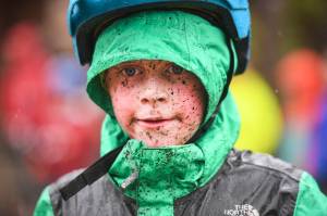 Mud splatters across the face of Alexander Andrews, 7, as he finishes second in the Douglas Dirt Derby Youth Bike Race for 5 to 7-year-olds at Savikko Park and the Treadwell Mine Historic Trail on Saturday, Oct. 5, 2019. The event was organized by the Juneau Freewheelers Bicycle Club. (Michael Penn | Juneau Empire)
