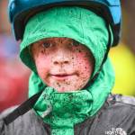 Mud splatters across the face of Alexander Andrews, 7, as he finishes second in the Douglas Dirt Derby Youth Bike Race for 5 to 7-year-olds at Savikko Park and the Treadwell Mine Historic Trail on Saturday, Oct. 5, 2019. The event was organized by the Juneau Freewheelers Bicycle Club. (Michael Penn | Juneau Empire)