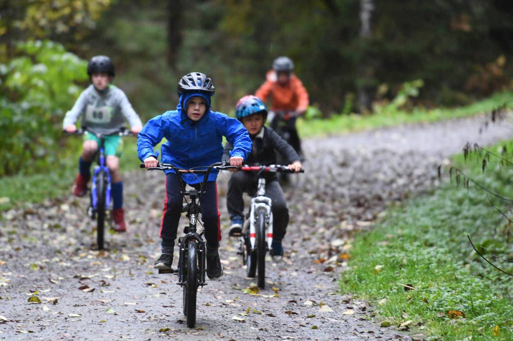 Riders take a fun run lap during the Douglas Dirt Derby Youth Bike Race at Savikko Park and the Treadwell Historic Trail on Saturday, Oct. 5, 2019. The event was organized by the Juneau Freewheelers Bicycle Club. (Michael Penn | Juneau Empire)