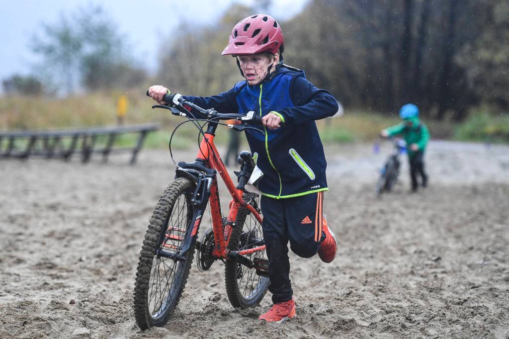Rawley Cox, 7, runs his bike across the finish line of the Douglas Dirt Derby Youth Bike Race for 5 to 7-year-olds at Savikko Park and the Treadwell Historic Trail on Saturday, Oct. 5, 2019. The event was organized by the Juneau Freewheelers Bicycle Club. (Michael Penn | Juneau Empire)