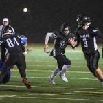 Juneaus Cooper Kriegmont, center, follows blocking by teammates Dawson Hickok, left, Wallace Adams and Gaby Soto, right, against Bartlett at Adair-Kennedy Memorial Field on Saturday, Oct. 5, 2019. Juneau won 67-24. (Michael Penn | Juneau Empire)