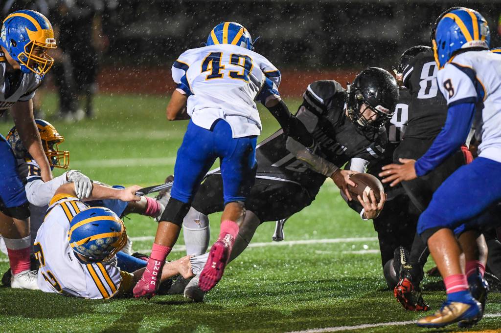 Juneaus Cooper Kriegmont is kept from scoring by Bartletts Iolana Haines, left, and Jasiah White at Adair-Kennedy Memorial Field on Saturday, Oct. 5, 2019. Juneau won 67-24. (Michael Penn | Juneau Empire)