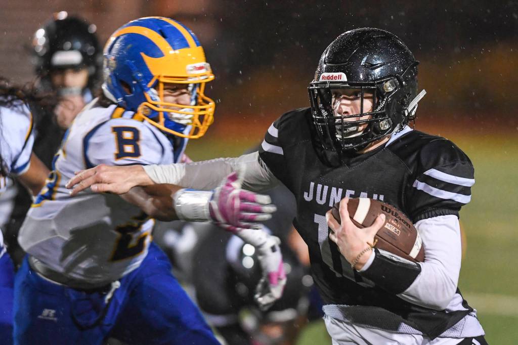 Juneaus Cooper Kriegmont runs against Bartletts Kainoa Duarte at Adair-Kennedy Memorial Field on Saturday, Oct. 5, 2019. Juneau won 67-24. (Michael Penn | Juneau Empire)