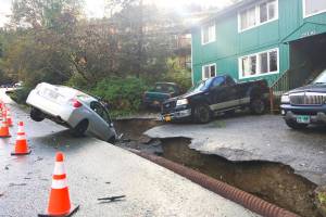 Emily Weirs car fell into chasm washed away on John Street in Douglas the evening of Oct. 5, 2015. Heavy rains in Juneau washed out roads, caused mudslides and damaged houses. (Michael S. Lockett | Juneau Empire)