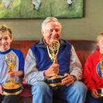 Wayne Fitzgerald, prolific and prodigious title sequence designer, is flanked by his grandsons, Bodhi and Portern Nelson of Juneau. All three hold awards earned by the late Fitzgerald over the course of his long career. (Courtesy Photo | Courtney Mico-Nelson)