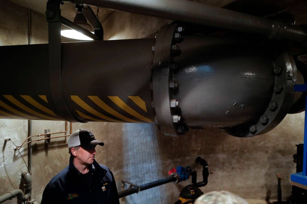 Scott Simonson, a senior wastewater collection officers for the city, stands underneath an outgoing wastewater pipe at theOuter Drive Pumping Station downtown on Friday, Oct. 11, 2019. The three pumps were overwhelmed during last weekends storm and caused a backup of sewage into the Mayor Bill Overstreet Park utilities building. (Michael Penn | Juneau Empire)