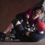 Jennifer Gross gets pulled down as Empire reporter Michael S. Lockett falls at the Pipeline Skate Park on Friday, Oct. 11, 2019. (Michael Penn | Juneau Empire)