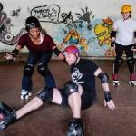 Empire reporter Michael S. Lockett takes a fall while being taught to rollerskate by Jennifer Gross, left, and Shabadrang Khalsa at the Pipeline Skate Park on Friday, Oct. 11, 2019. (Michael Penn | Juneau Empire)