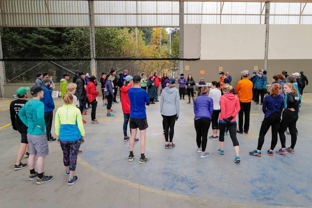 Juneau residents gather for pre-race instructions before the annual community mental health run, the Extra Tough 5K & 1 Mile Run, on Saturday, Oct. 12, 2019, at Riverbend Elementary School. The run is sponsored by National Alliance on Mental Illness (NAMI) Juneau. (Michael Penn | Juneau Empire)