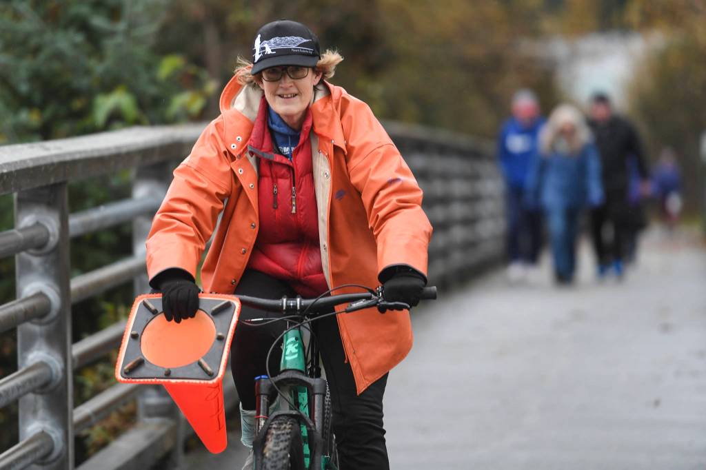 Sandi Pahlke, President of National Alliance on Mental Illness (NAMI) Juneau and race director, sets up the annual community mental health run, the Extra Tough 5K & 1 Mile Run, on Saturday, Oct. 12, 2019, starting at Riverbend Elementary School. The run is sponsored by National Alliance on Mental Illness (NAMI) Juneau. (Michael Penn | Juneau Empire)