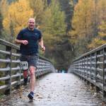 Brandon Ivanowicz takes the lead in the annual community mental health run, the Extra Tough 5K & 1 Mile Run, on Saturday, Oct. 12, 2019, at Riverbend Elementary School. The run is sponsored by National Alliance on Mental Illness (NAMI) Juneau. (Michael Penn | Juneau Empire)