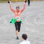 Colleen Jones celebrates her finish at the annual community mental health run, the Extra Tough 5K & 1 Mile Run, on Saturday, Oct. 12, 2019, at Riverbend Elementary School. The run is sponsored by National Alliance on Mental Illness (NAMI) Juneau. (Michael Penn | Juneau Empire)