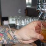 Zac Watt pours beer into a four-ounce glass for a beer flight during Forbidden Peak Brewerys grand opening, Saturday, Oct. 12, 2019. (Ben Hohenstatt | Juneau Empire)