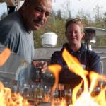 Francisco Gonzalez and Charlotte Linton warm up by Forbidden Peak Brewerys tabletop fireplace that works like a patio space heater. The two were among the crowd at Forbidden Peak Brewerys grand opening, Saturday, Oct. 12, 2019. (Ben Hohenstatt | Juneau Empire)