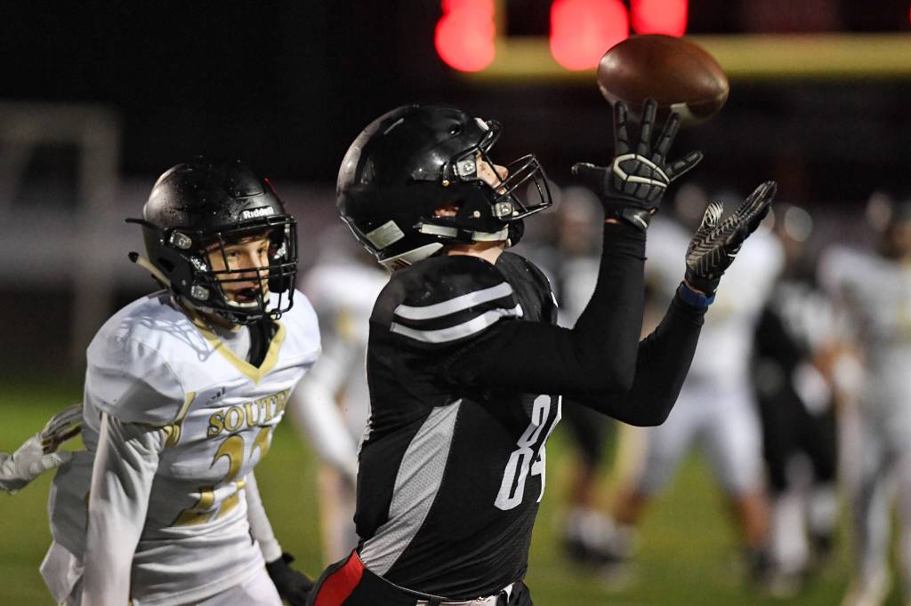 Juneaus Dawson Hickok catches a long pass against South Anchorages Aidan Ohlson at Adair-Kennedy Memorial Field on Saturday, Oct. 12, 2019. (Michael Penn | Juneau Empire)