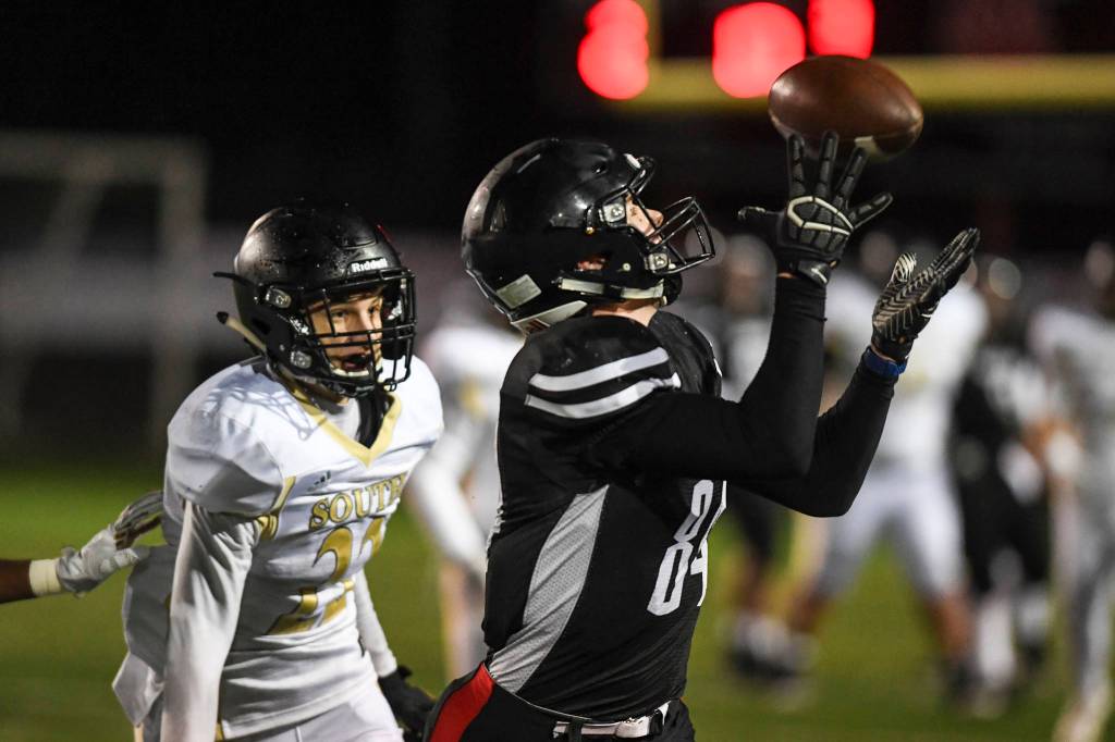 Juneaus Dawson Hickok, right, catches a long pass in front of South Anchorages Aidan Ohlson at Adair-Kennedy Memorial Field on Saturday, Oct. 12, 2019. South Anchorage won 54-14. (Michael Penn | Juneau Empire)
