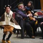 Richard Chalyee Éesh Peterson, President of the Central Council of Tlingit and Haida Indian Tribes of Alaska, holds Guillermo Contreras, 3, as Tristen Washington, 9, of the Xaadaas Dagwii Dance Group performs at the Elizabeth Peratrovich Hall for Indigenous Peoples Day on Monday, Oct. 14, 2019. (Michael Penn | Juneau Empire)
