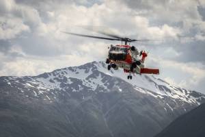 An aircrew aboard an MH-60 Jayhawk helicopter makes an approach on their return to Coast Guard Air Station Kodiak, Alaska, June 5, 2019. (U.S. Coast Guard photo by Petty Officer 1st Class Bradley Pigage.)