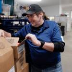 Southeast Alaska Food Bank President Dave Lefebvre checks on meat donated by Fred Meyer at the Southeast Alaska Food Bank on Crazy Horse Drive on Tuesday, Oct. 15, 2019. (Michael Penn | Juneau Empire)