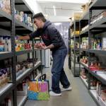 Volunteer Michael Starr restocks shelves at the Southeast Alaska Food Bank on Crazy Horse Drive on Tuesday, Oct. 15, 2019. (Michael Penn | Juneau Empire)