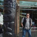 Tsimshian artist David R. Boxley stands by their bronze house posts during an unveiling ceremony in front of the Walter Soboleff Center by Sealaska Heritage Institute on Sunday, Aug. 26, 2018. (Michael Penn | Juneau Empire File)