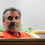 Brian Steven Smith looks out in the courtroom while waiting for his arraignment to start Wednesday, Oct. 16, 2019, in Anchorage, Alaska. A public defender entered not guilty pleas for Smith, who is accused of documenting the assault and murder of Kathleen Henry in an Anchorage hotel. (AP Photo/Mark Thiessen)