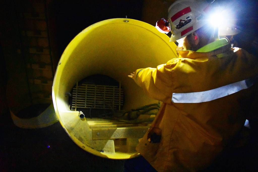Kensington Mine General Manager Mark Kiessling shows an escape tube to be used by workers in the event of an emergency on Monday, Oct. 14, 2019. (Peter Segall | Juneau Empire)