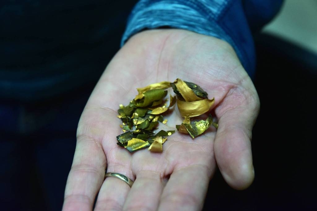 Lab manager Vanessa Watson holds gold from the quality testing process at the Kensington Mine on Monday, Oct. 14, 2019. (Peter Segall | Juneau Empire)