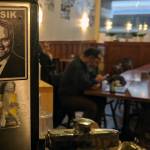 A sticker featuring Gov. Mike Dunleavy and the uniquely Alaskan insult, Oosik, can be seen in the Rookery Cafe. The artist behind the sticker Matt Hamilton said he bears Dunleavy no ill will. (Ben Hohenstatt | Capital City Weekly)