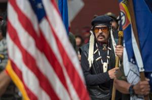 Wayne Smallwood lines up with the Southeast Alaska Native Veterans honor guard to lead dance groups parade through downtown Juneau on Saturday, June 9, 2018. (Michael Penn | Juneau Empire)