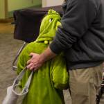 A parent hugs his child as members of the Parents as Teachers program and a number of children visited the Juneau Pioneer Home to have an early Halloween with the residents on Tuesday, Oct. 22, 2019. (Michael S. Lockett | Juneau Empire)