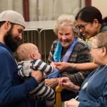 Residents of the Juneau Pioneer Home play with a baby as members of the Parents as Teachers program and a number of children visited to have an early Halloween on Tuesday, Oct. 22, 2019. (Michael S. Lockett | Juneau Empire)