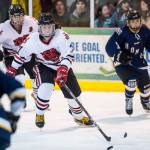 Juneau-Douglas Chance Turinsky, center, moves the puck against Homer at Treadwell Arena on Friday, Jan. 18, 2019. JDHS won 4-3 in overtime. (Michael Penn | Juneau Empire File)