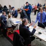 Sen. Jesse Kiehl, D-Juneau, right, visits the employer table manned by Don Habeger as he participates in a Reentry Simulation event at the Elizabeth Peratrovich Hall on Tuesday, Oct. 29, 2019. The event was sponsored by Central Council of the Tlingit & Haida Indian Tribes of Alaska in partnership with the Juneau Reentry Coalition and Alaska Mental Health Trust. (Michael Penn | Juneau Empire)