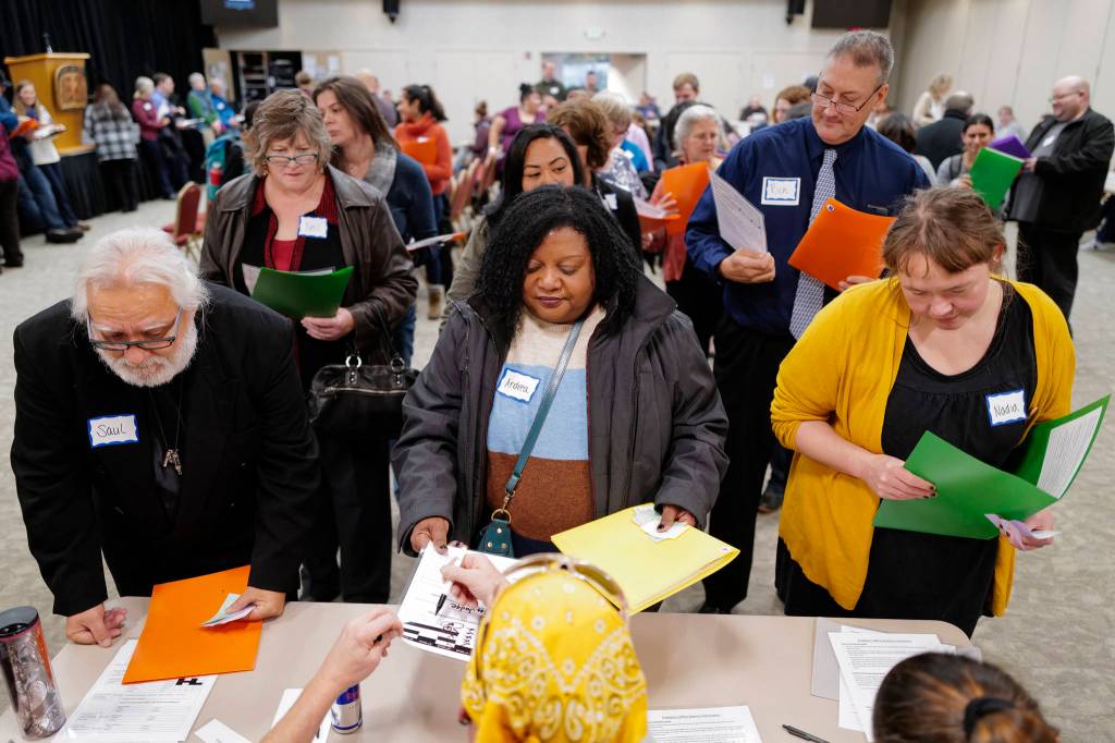 Juneau residents stand in line to check in with probation officers as they participate in a Reentry Simulation event at the Elizabeth Peratrovich Hall on Tuesday, Oct. 29, 2019. The event was sponsored by Central Council of the Tlingit & Haida Indian Tribes of Alaska in partnership with the Juneau Reentry Coalition and Alaska Mental Health Trust. (Michael Penn | Juneau Empire)