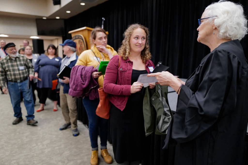 Selina Finley, center, reluctantly listens to a judgment by the Judge, played by Teri Tibbett, right, during a Reentry Simulation event at the Elizabeth Peratrovich Hall on Tuesday, Oct. 29, 2019. The event was sponsored by Central Council of the Tlingit & Haida Indian Tribes of Alaska in partnership with the Juneau Reentry Coalition and Alaska Mental Health Trust. (Michael Penn | Juneau Empire)