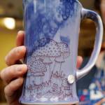 Mercedes Muñoz displays one of her mugs fresh out of her home studio on Monday, Oct. 28, 2019, as she prepares for a First Friday show at Coppa. (Michael Penn | Juneau Empire)