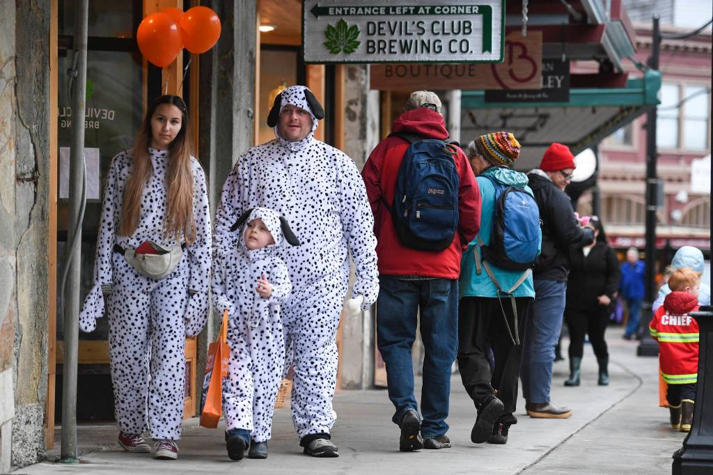 Brian, Alicia and Ares Ritter make it a family affair during the Trick or Treat Downtown event on Thursday, Oct. 31, 2019. More than 70 business put out orange balloons to participate in the event aimed at young children. (Michael Penn | Juneau Empire)