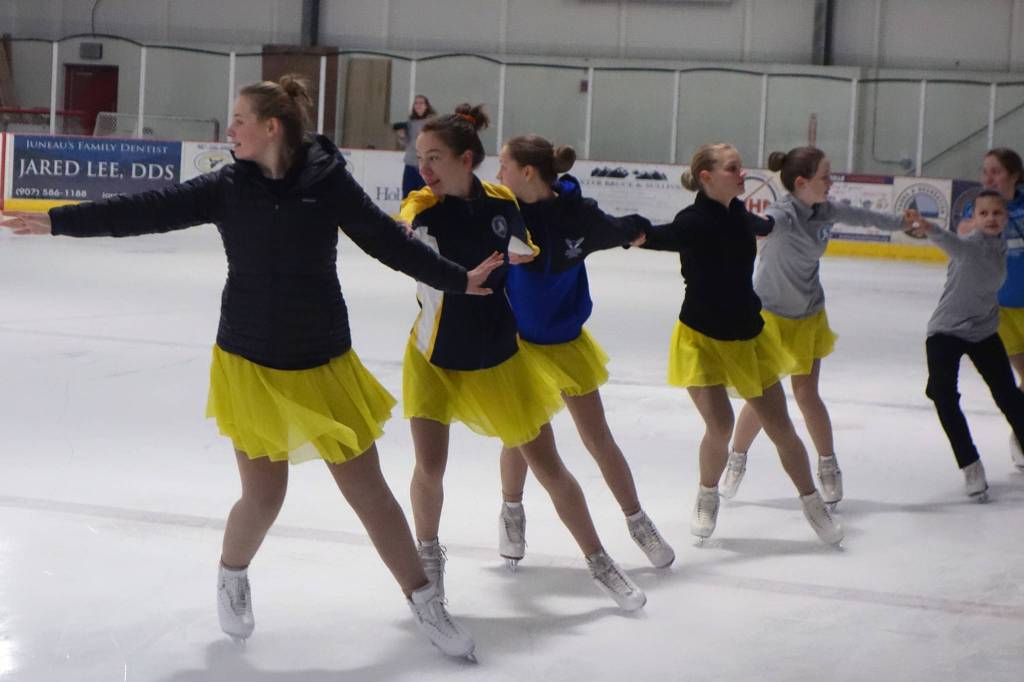 Team Forget Me Not, a synchronized figure skating team, practices before a performance at Treadwell Arena, Saturday, Nov. 2, 2019. Toward the end of the practice session, team members donned jackets. (Ben Hohenstatt | Juneau Empire)