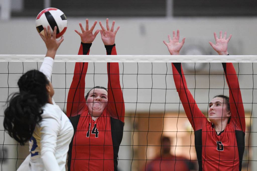 Thunder Mountains Mariah Tanuvasa-Tuvaifale, left, places the ball of Juneau-Douglas Gabi Griggs, center, and Addie Prussing at Juneau-Douglas High School: Yadaa.at Kalé on Friday, Nov. 1, 2019. Thunder Mountain won 3-0 (25-14, 25-20, 25-20). ( Michael Penn | Juneau Empire)