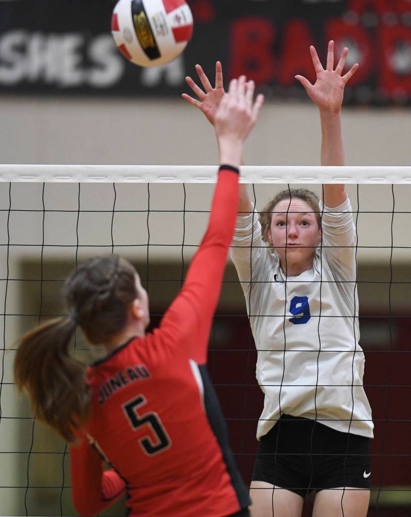 Thunder Mountains Sophie Harvey, right, attempts to block a spike by Juneau-Douglas Brooke Sanford at Juneau-Douglas High School: Yadaa.at Kalé on Friday, Nov. 1, 2019. Thunder Mountain won 3-0 (25-14, 25-20, 25-20). ( Michael Penn | Juneau Empire)